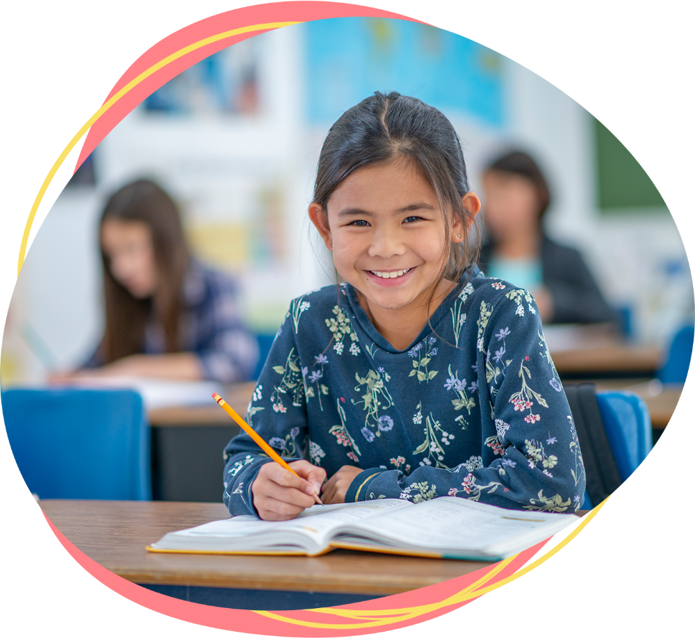 Student writing at desk